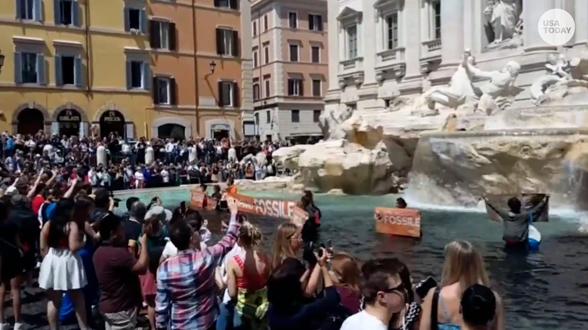 Featured image for Climate activists darken Trevi Fountain in protest against deadly floods.