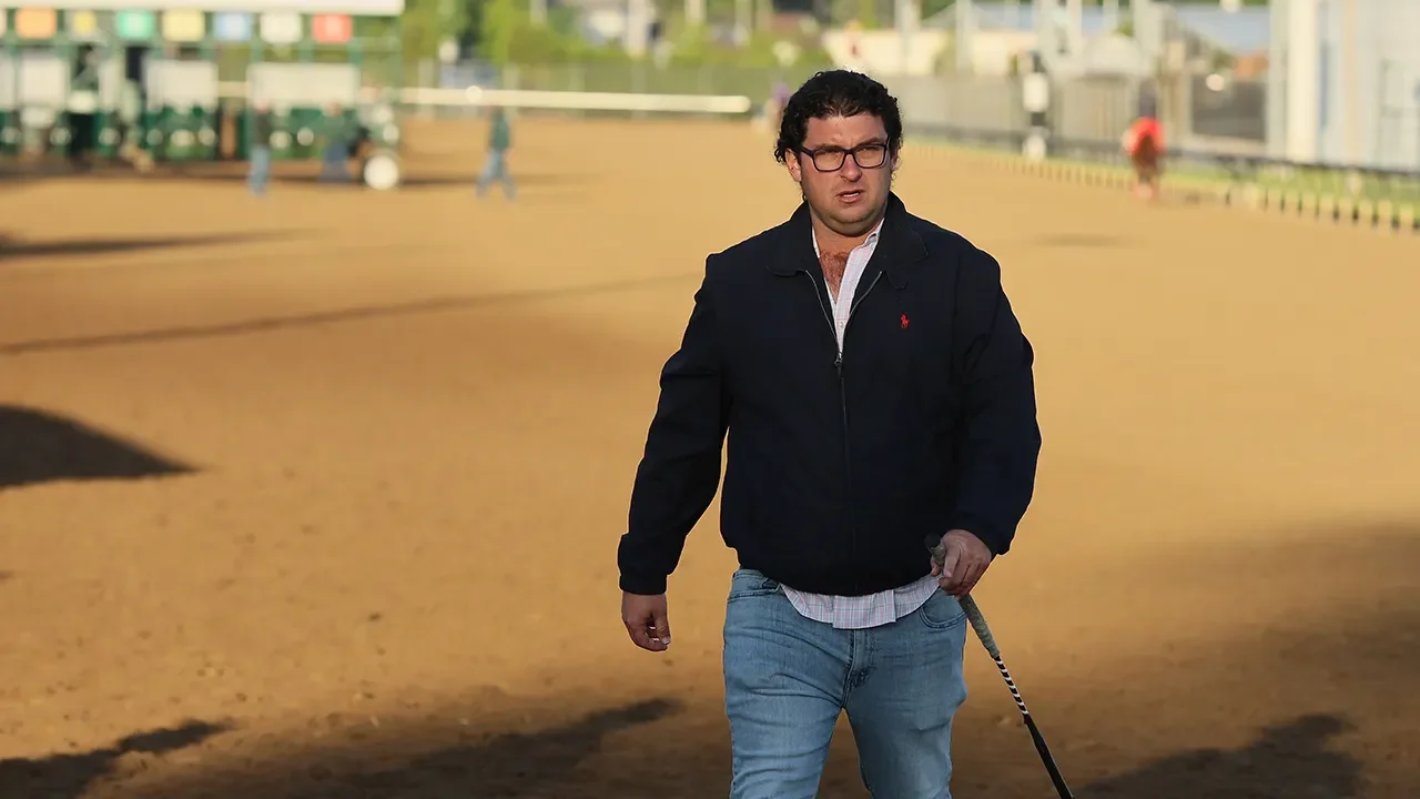 Churchill Downs suspends trainer after multiple horse deaths.