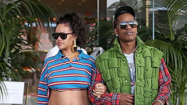 Rihanna flaunts baby bump while holding hands with A$AP Rocky.
