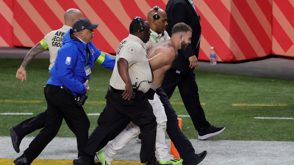 Featured image for "Security Tackles Shirtless Fans Running Onto Field at Super Bowl 58"