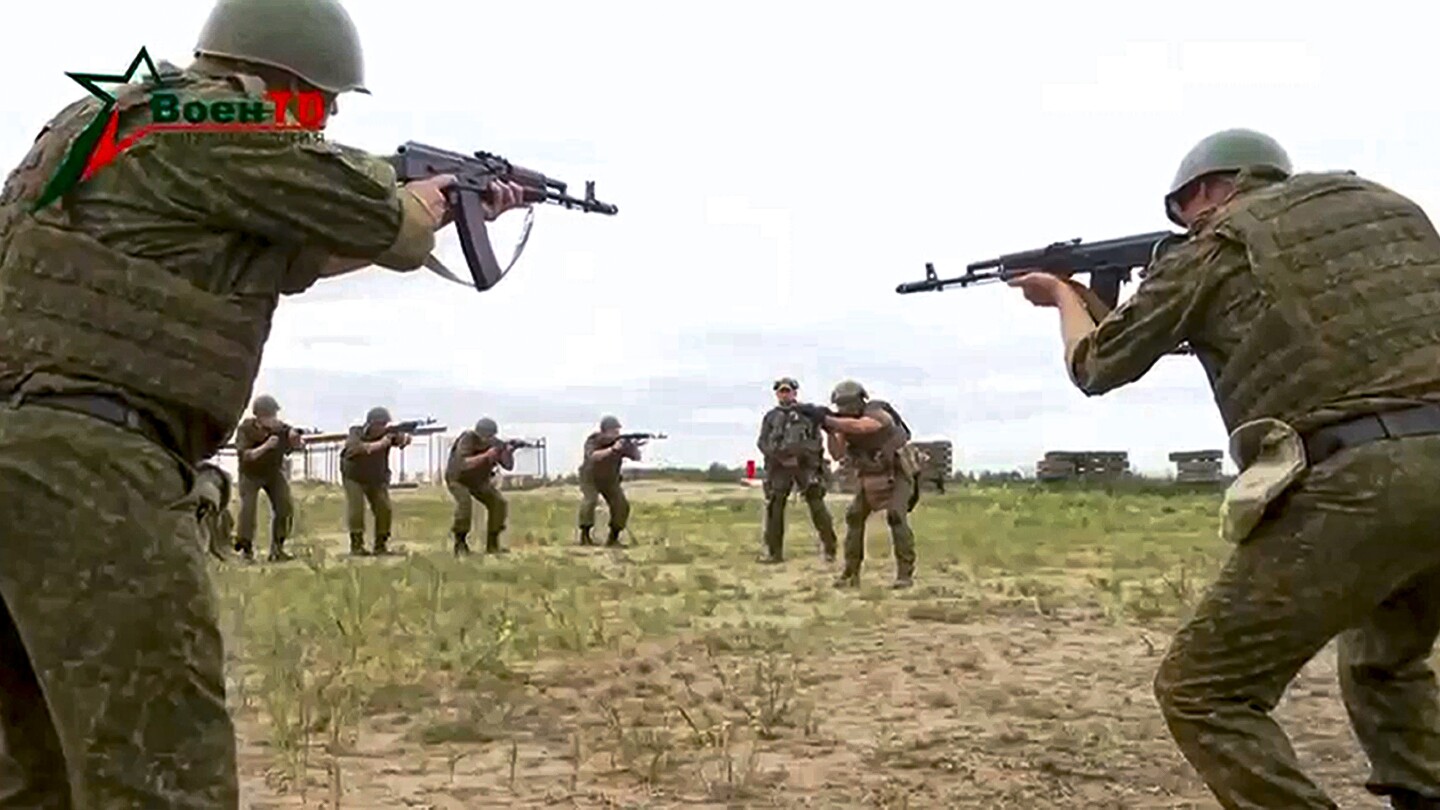 "Russian Flags Fly as Wagner Troops Arrive in Belarus, Resolving Mutiny"