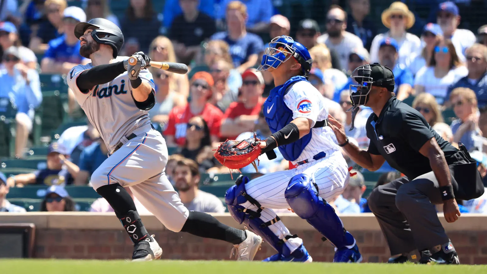 Cubs display scrappiness but fall to Marlins in 14-inning marathon.