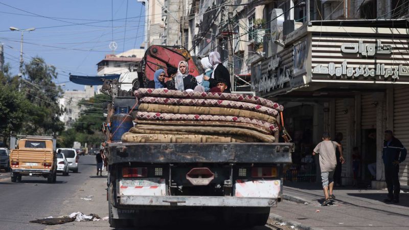 "Israel-Hamas Conflict: Gaza Residents Flee as Israeli Troops Amass at Border"