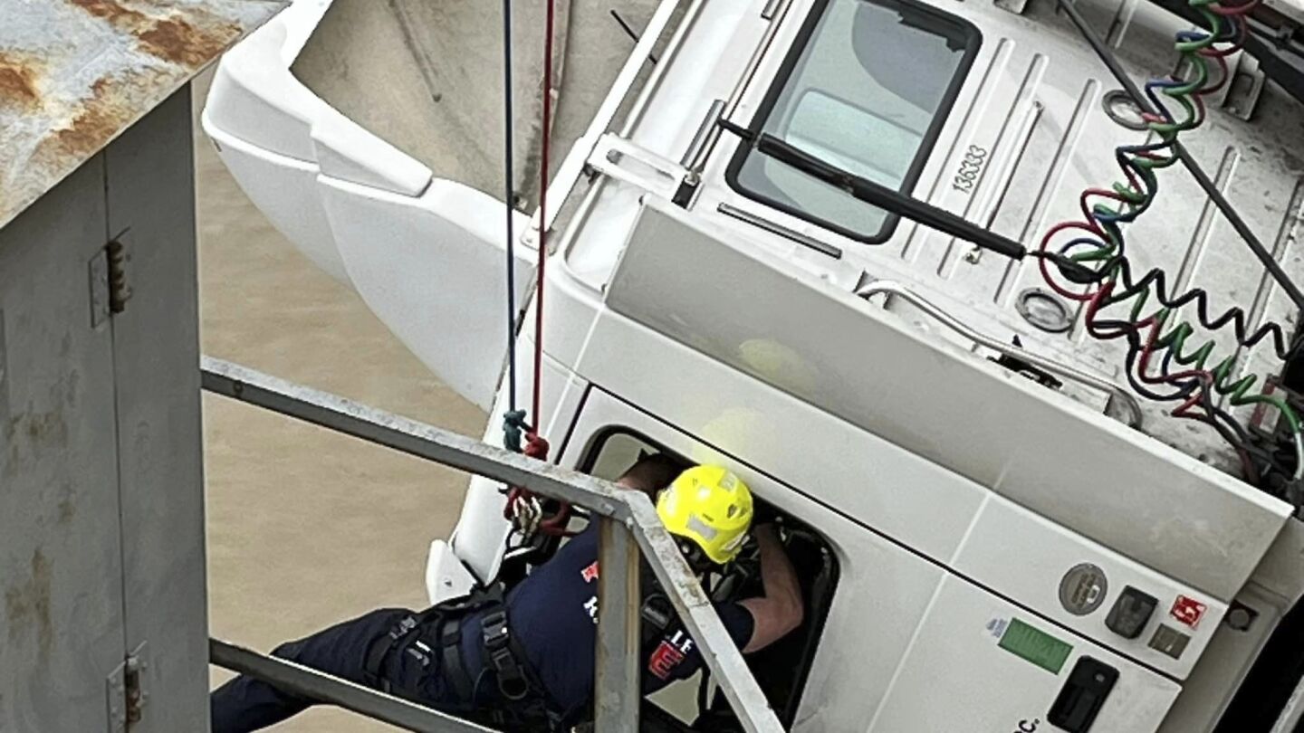 Featured image for "Firefighter Rescues Semi Driver Dangling from Louisville Bridge Edge"