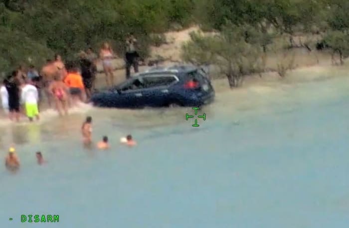 DUI driver crashes into water on Florida beach, nearly hits child.
