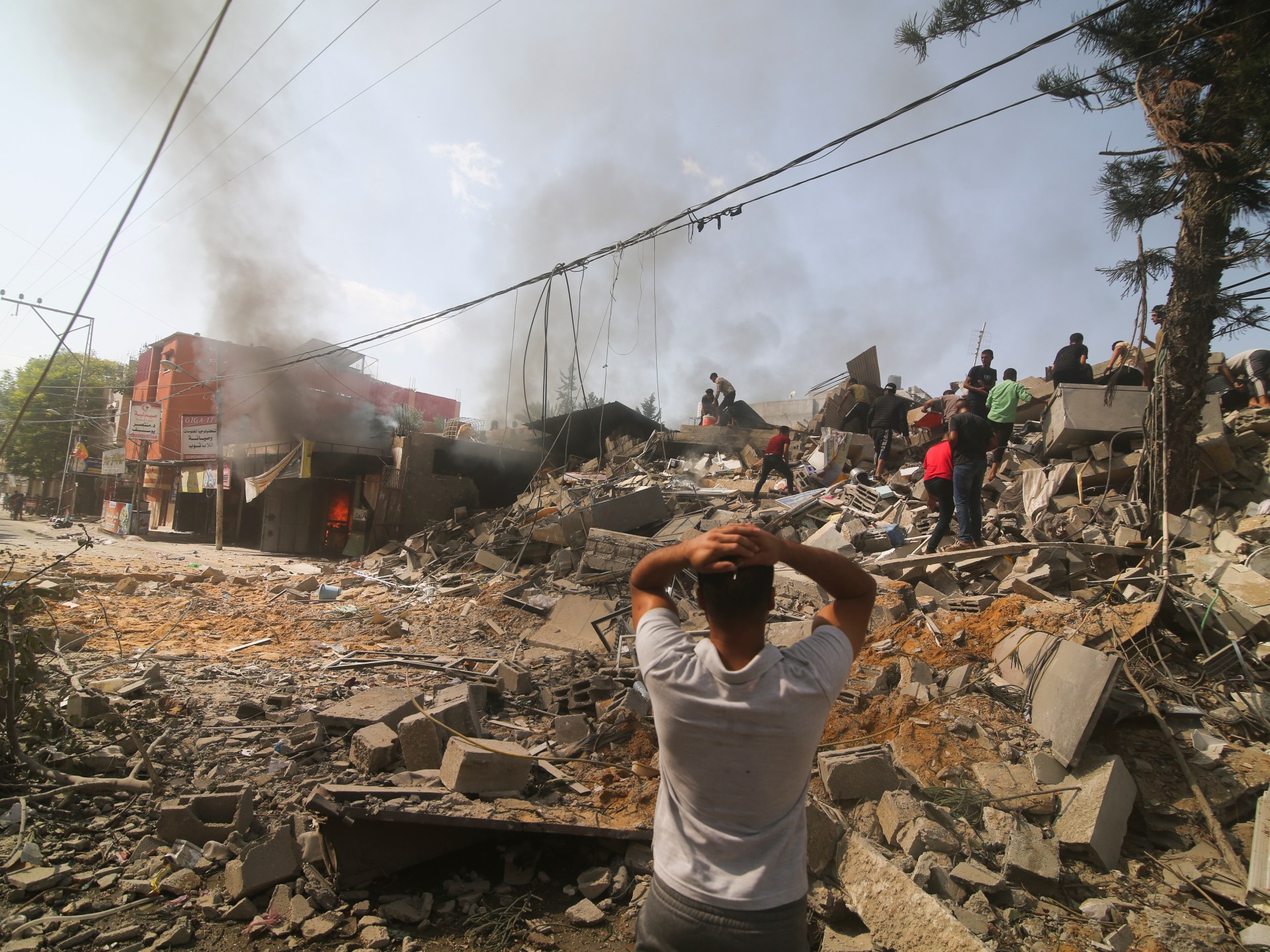 "Israel-Hamas War: Mounting Gaza Deaths, Hostages, and Macron's Visit - Day 18 Updates"