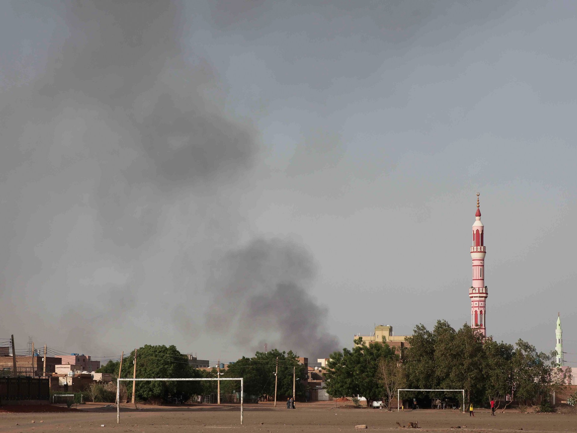 Sudanese factions battle for control of arms factory and fuel depots, putting neighboring South Sudan in danger.