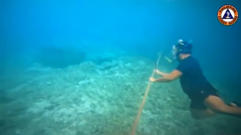 Tensions Escalate as Diver Cuts China's Sea Barrier in South China Sea