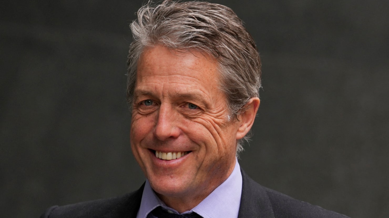 Featured image for Hugh Grant Reaches Settlement in Lawsuit Against The Sun Tabloid