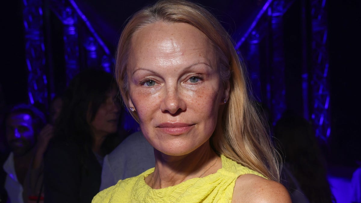 Featured image for Pamela Anderson's Makeup-Free Revolution: Embracing Natural Beauty at Paris Fashion Week