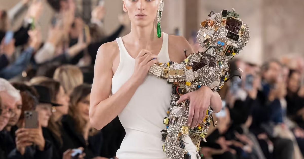 Featured image for "Robot Baby Covered in Old Flip Phones Steals the Show at Schiaparelli's Haute Couture Runway"