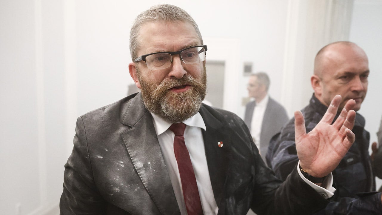"Far-right Polish Lawmaker's Antisemitic Act: Extinguishing Hanukkah Menorah in Parliament"