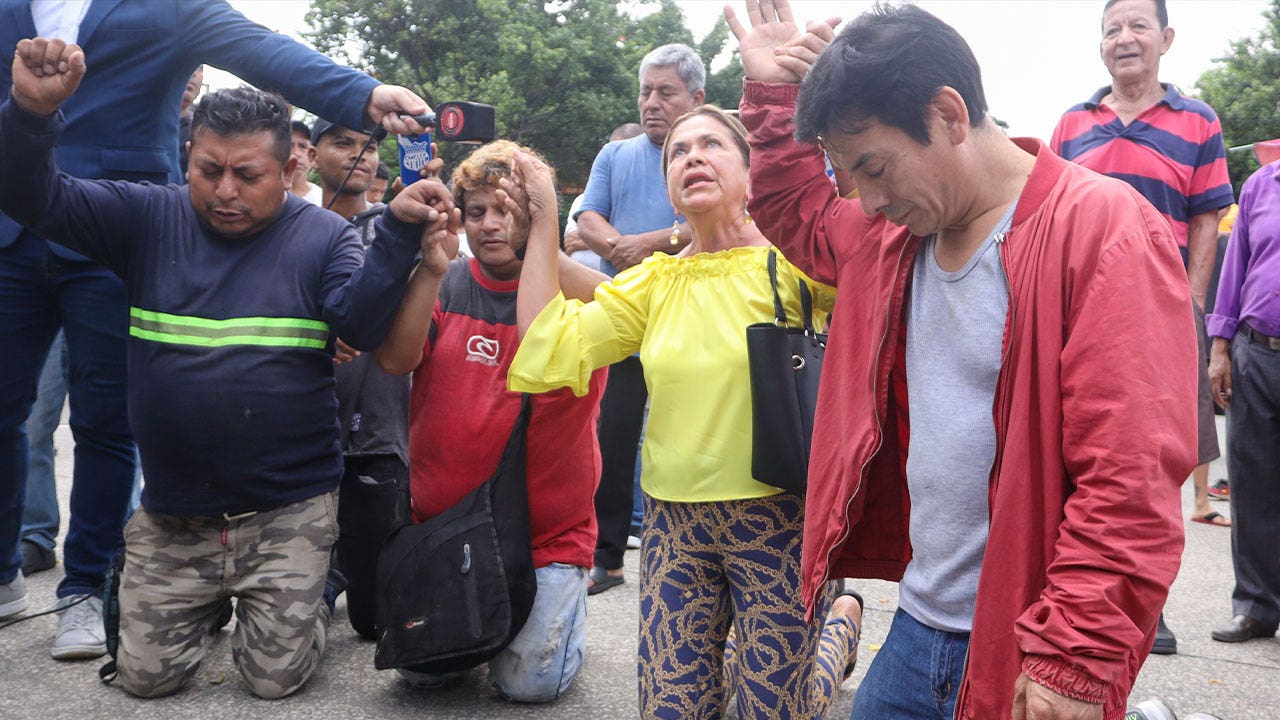Police in Ecuador rescue security guard with explosive vest.