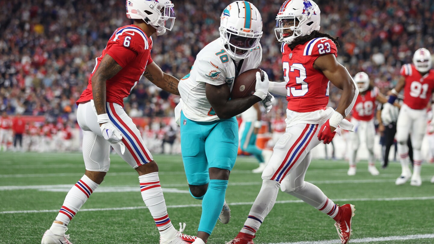 "Dolphins Defeat Patriots in Intense Showdown: Hill's Performance Shines"