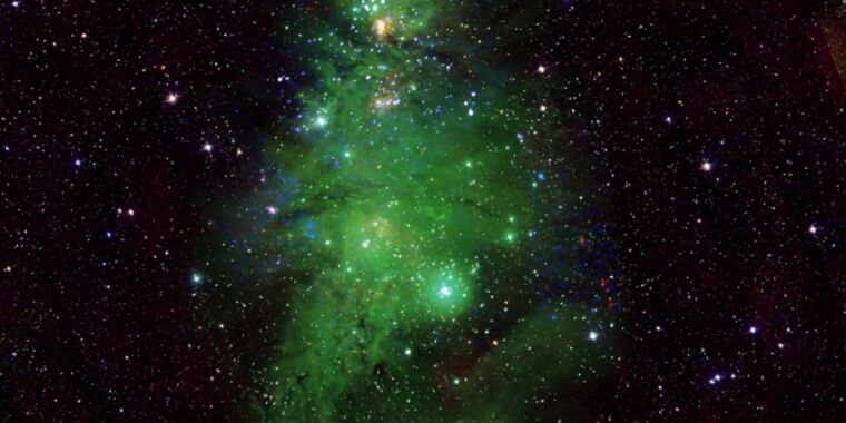 Featured image for Glowing Green: Telescopes Illuminate Christmas Tree Cluster in Space