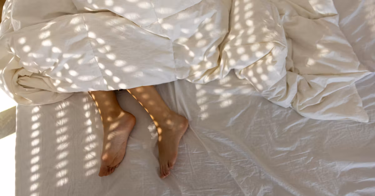 Featured image for Why Sleeping with One Foot Outside the Sheets Feels So Good