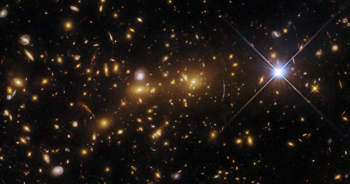 Hubble Telescope Discovers Einstein's Predicted Optical Illusion and Merging Galaxy Clusters