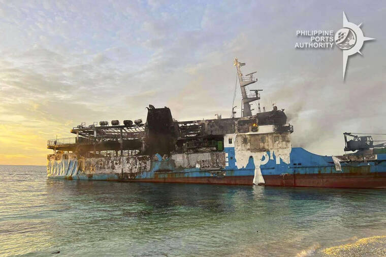 Filipino rescuers moved to tears by death scene in burned ferry.
