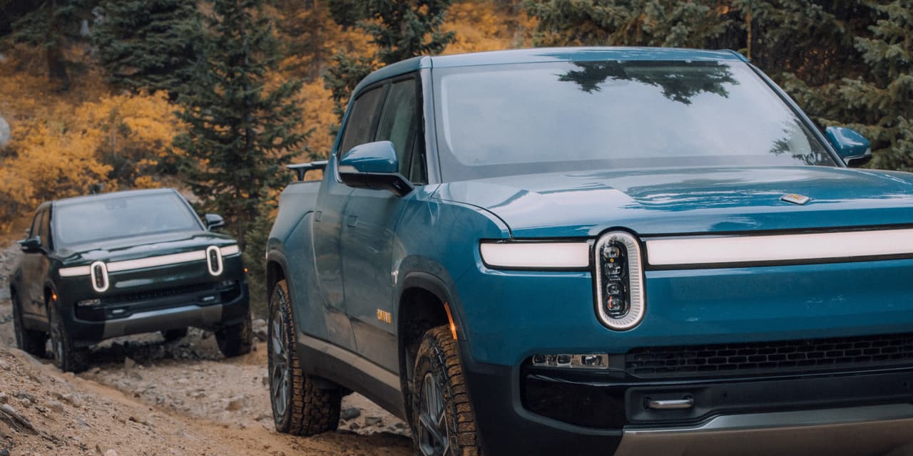 Rivian Faces Double Downgrade and Layoffs Amidst EV Market Challenges