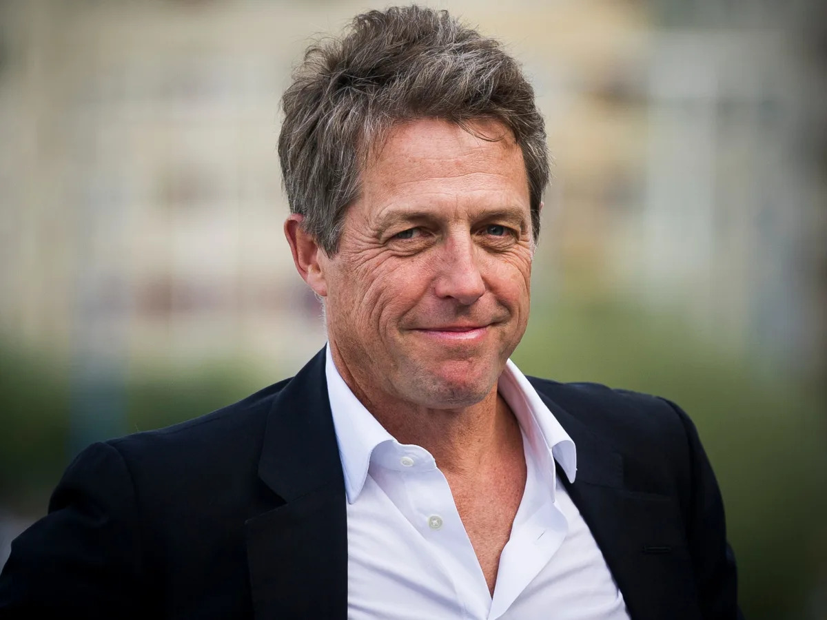 Featured image for Hugh Grant laments the lack of romance on modern movie sets due to mobile phones.
