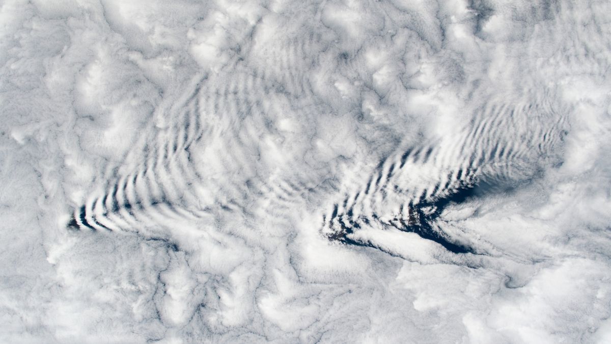 Featured image for "Gravity Waves Create Perfect Cloud Ripples Over Remote Islands"