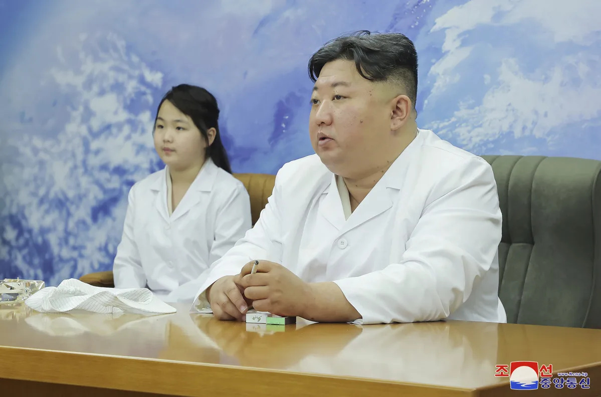 Kim Jong Un inspects North Korea's military spy satellite station with daughter.