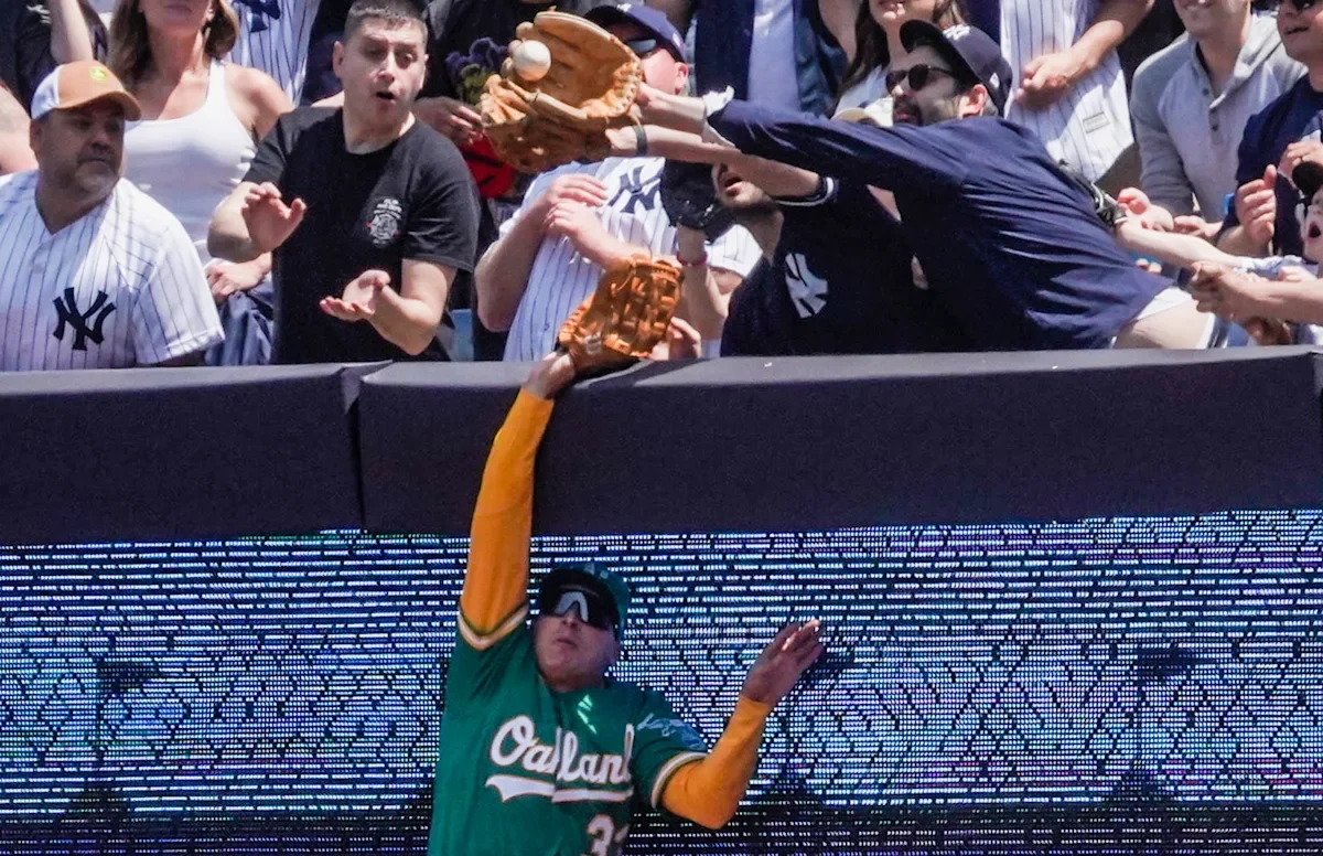Controversial fan interference leads to Yankees' 3-run HR against A's.