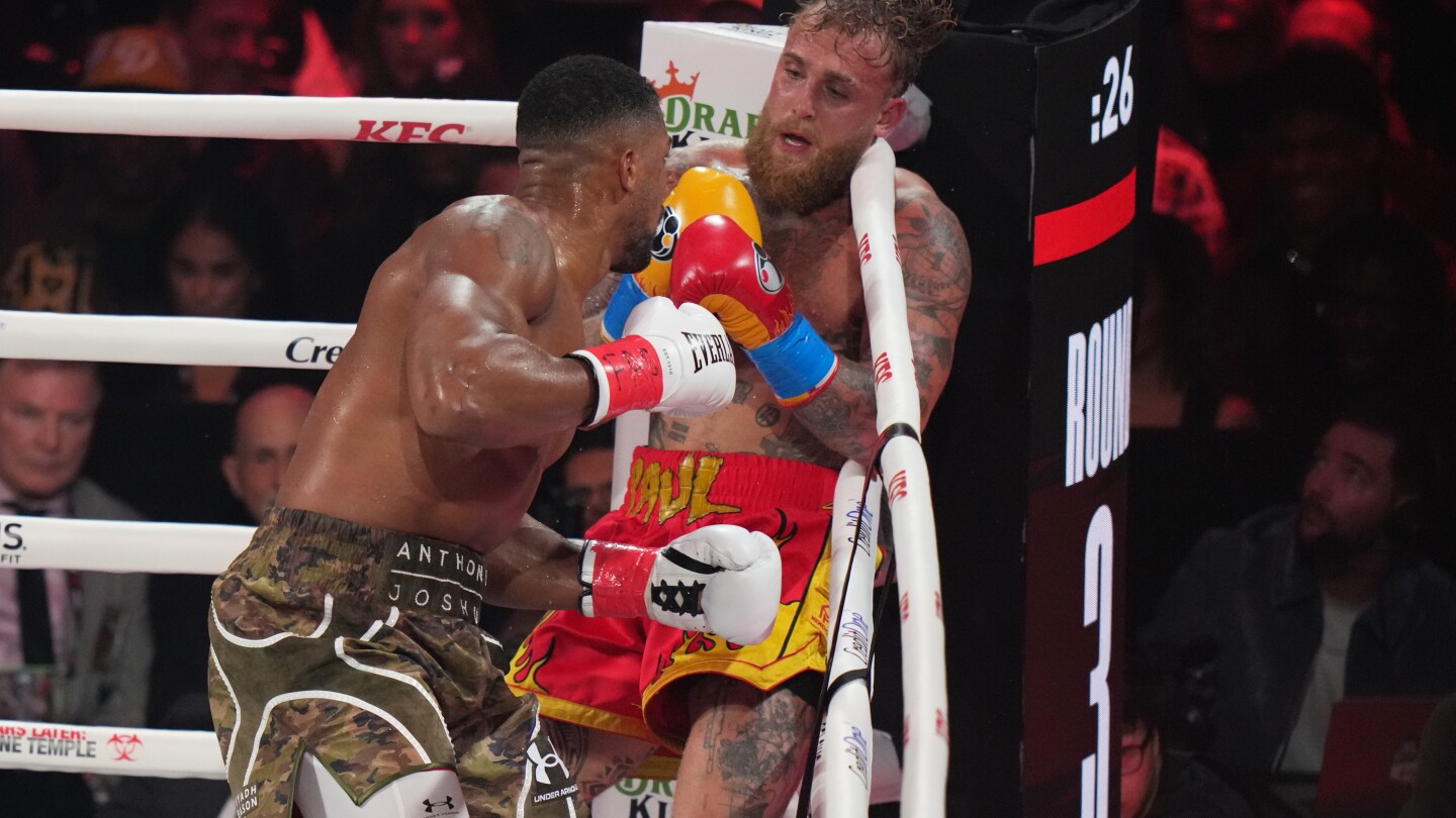 Featured image for Anthony Joshua KO's Jake Paul, leaving his jaw shattered in heavyweight clash