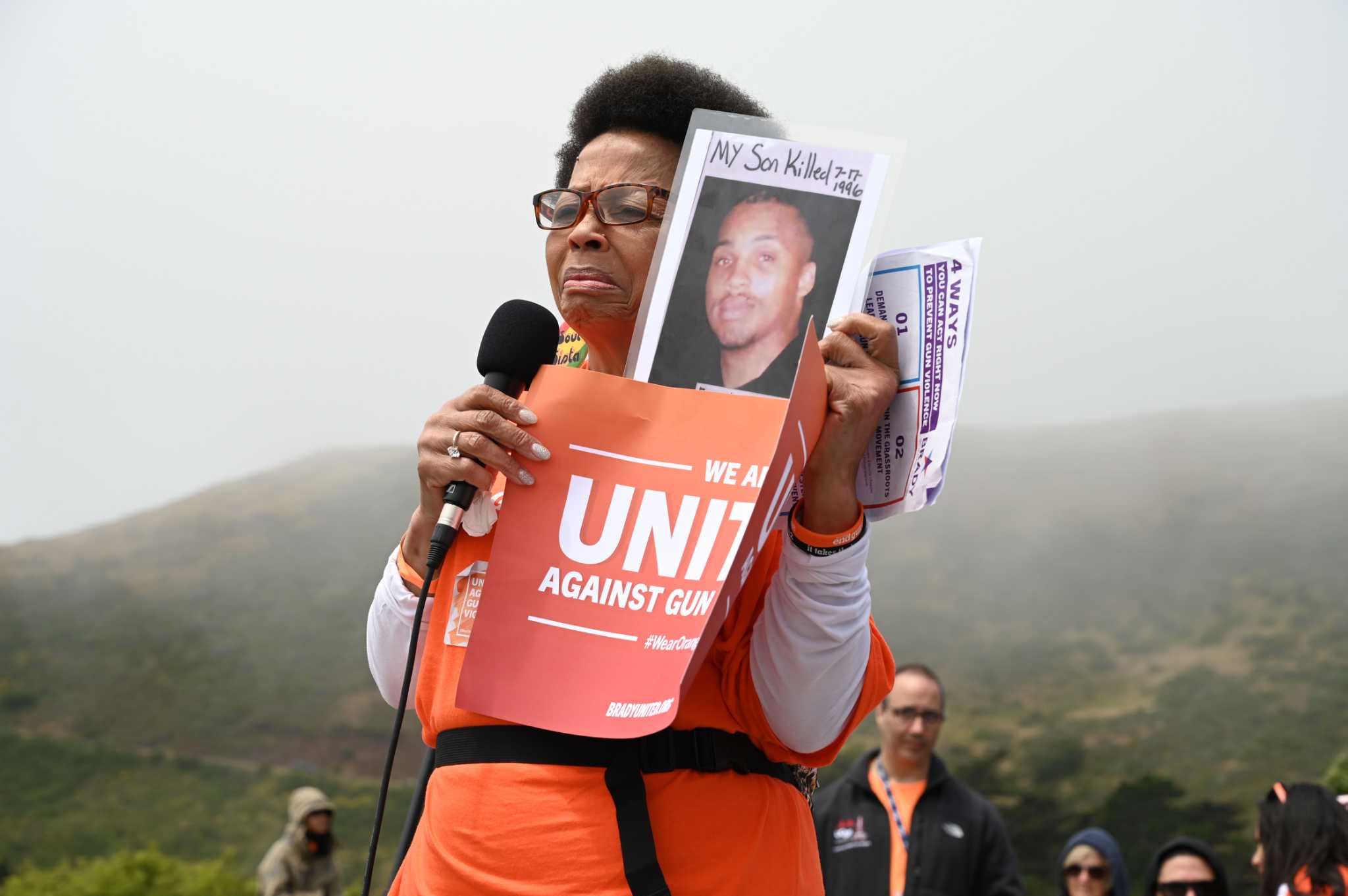 Orange-clad protesters march across Golden Gate Bridge to raise awareness on gun violence.