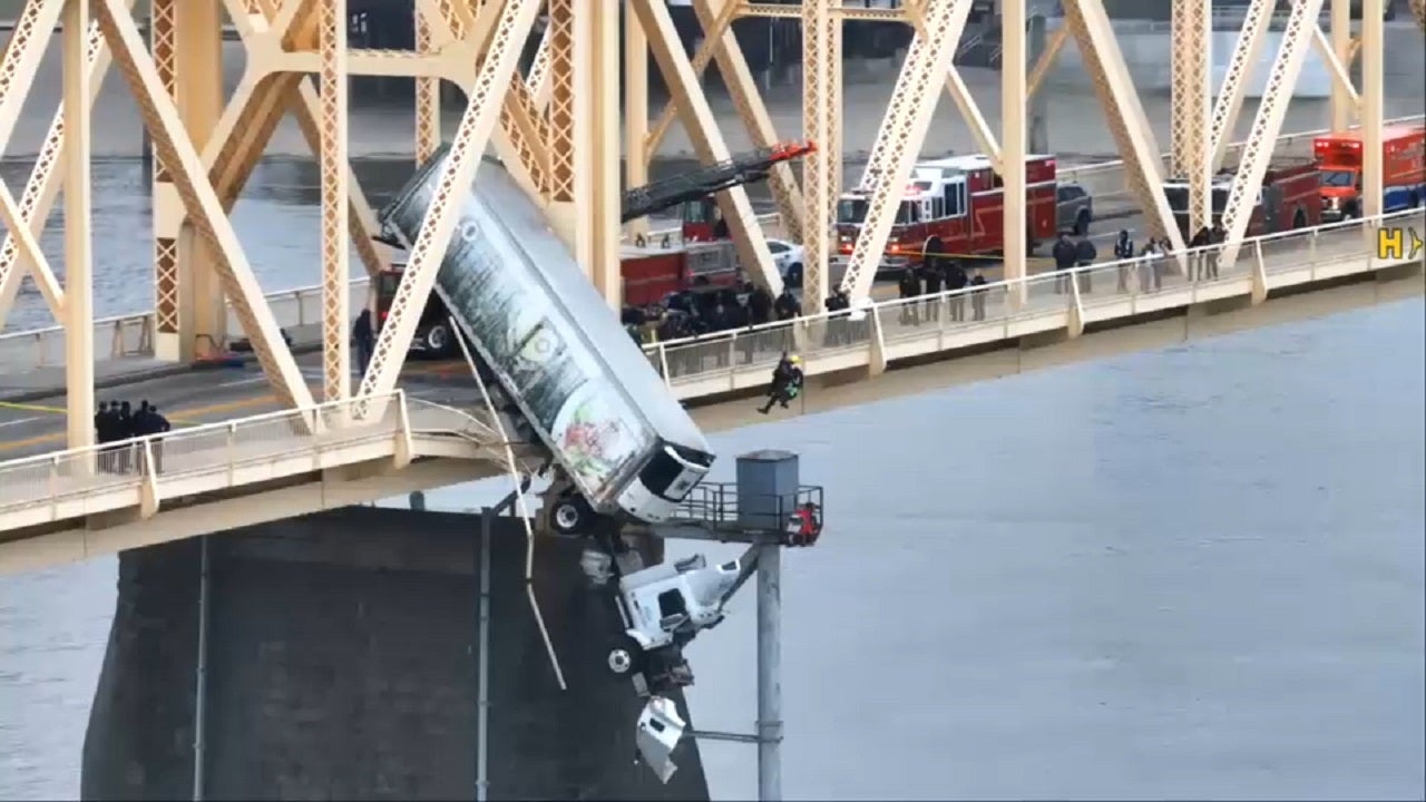 Featured image for Truck Driver Rescued from Dangling Semi-Truck After Bridge Crash