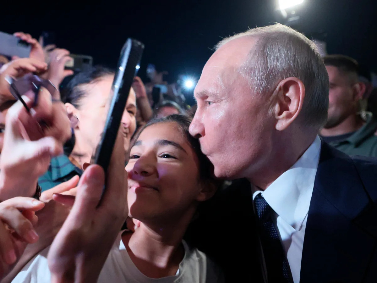 Featured image for "Putin's Surprising Selfies: From Long Tables to Kissing Regular Russians"
