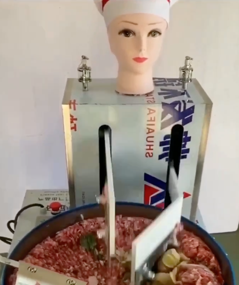 "Robot Lady Wields Devilish Knife to Chop Meat"