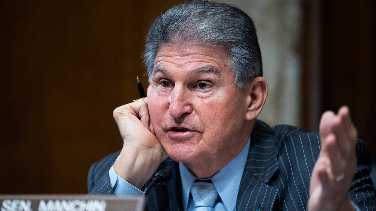 Manchin threatens legal action against Biden administration over EV tax credits.