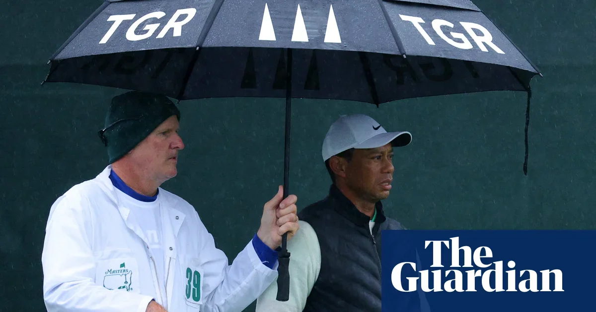 Tiger Woods survives Masters cut, advances to weekend play.