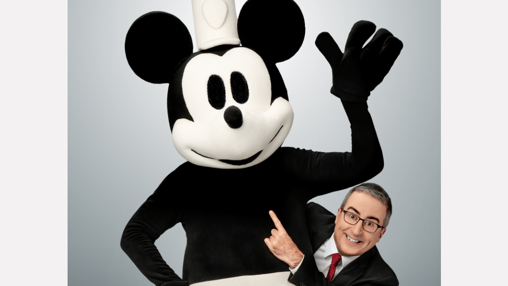 Featured image for "John Oliver Mocks Disney with Steamboat Willie Promo: 'What's Their Move, Sue?'"