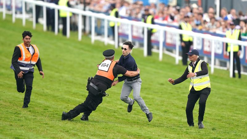 Animal rights protesters cause disruption and arrests at Epsom Derby.