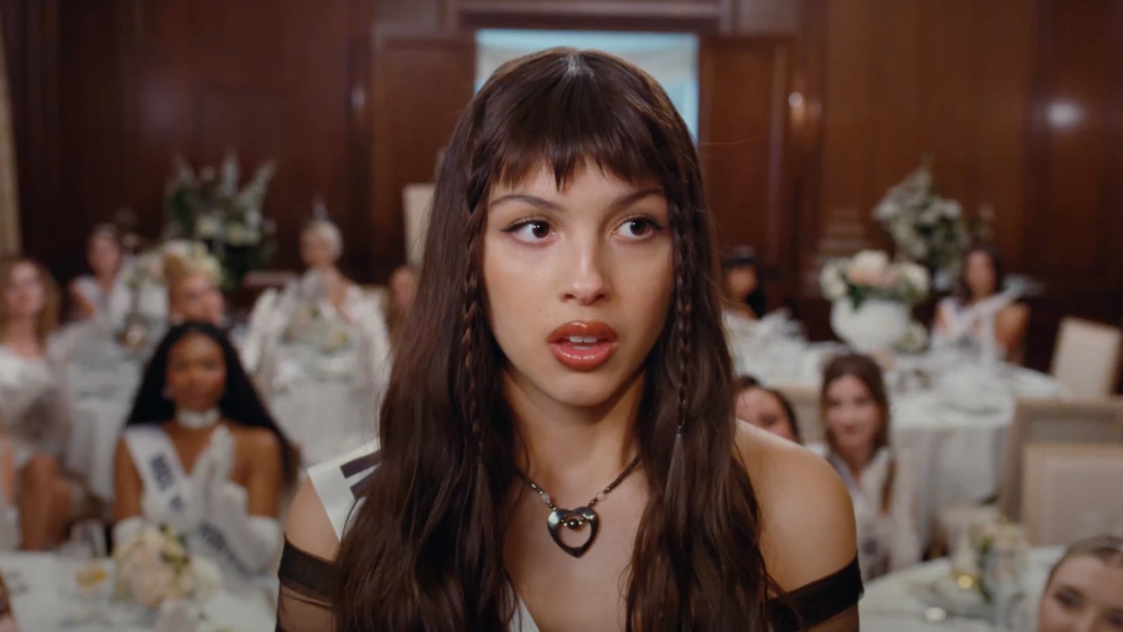 Featured image for "Olivia Rodrigo Teases Pageant-Themed 'Obsessed' Video Ahead of Deluxe 'GUTS' Release"