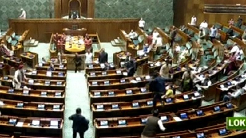 Featured image for "Shocking Security Breach: Intruder Jumps on Tables in India Parliament"