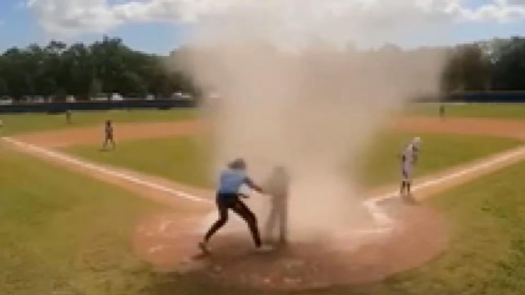 Featured image for Umpire rescues child from dust devil during youth baseball game.