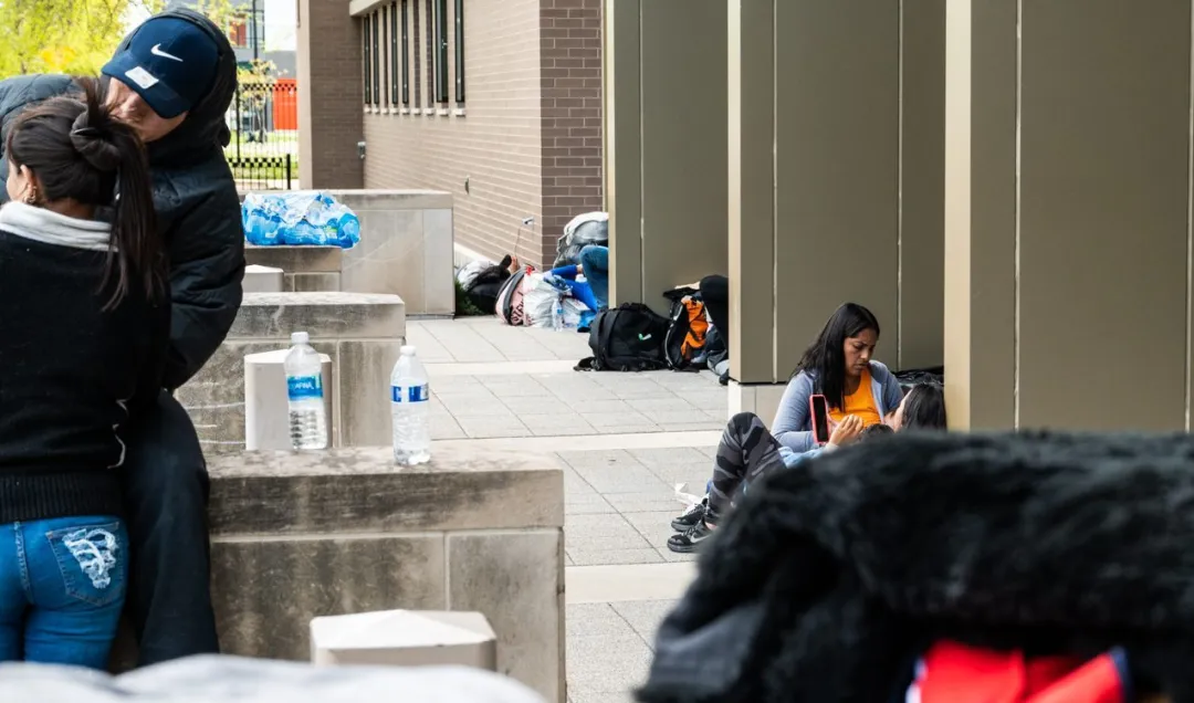 Migrants in Chicago face poor conditions and delays at city-run shelters.