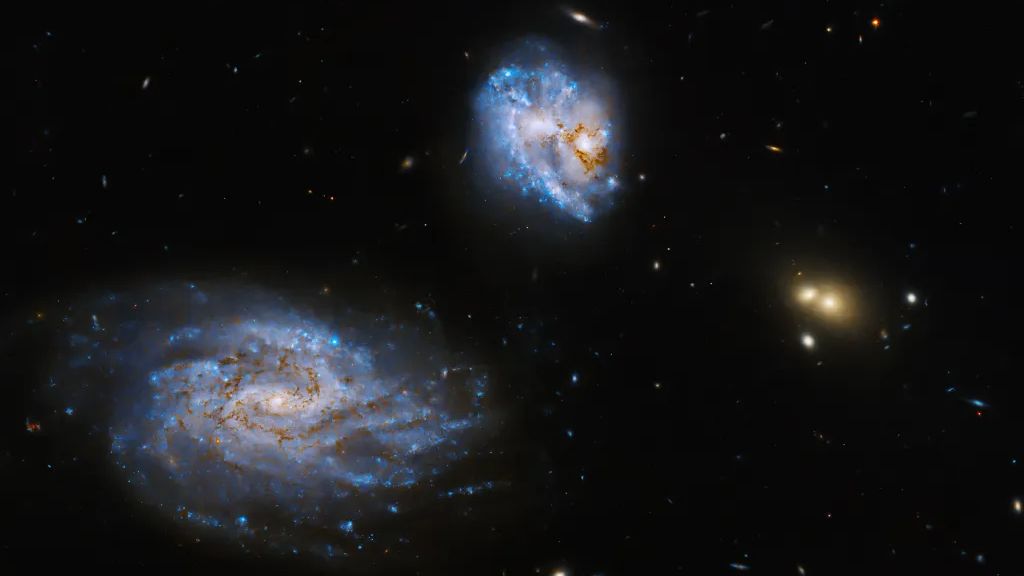 "Stunning Images: Hubble Captures Colliding Galaxies Illuminated by Stars"
