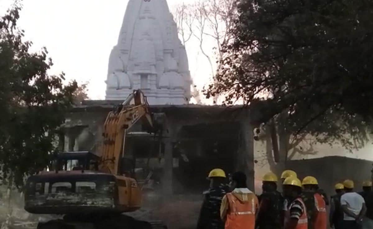 Featured image for Indore temple crackdown: Bulldozer demolishes illegal structures after tragedy.