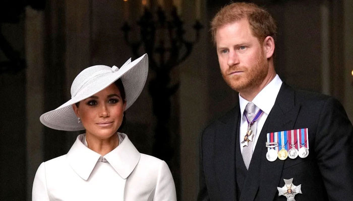 Featured image for Experts weigh in on Harry and Meghan's potential coronation appearance.