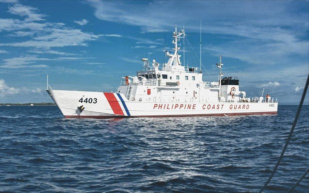 Tensions rise as Philippine Coast Guard and Chinese warship narrowly avoid collision in South China Sea.