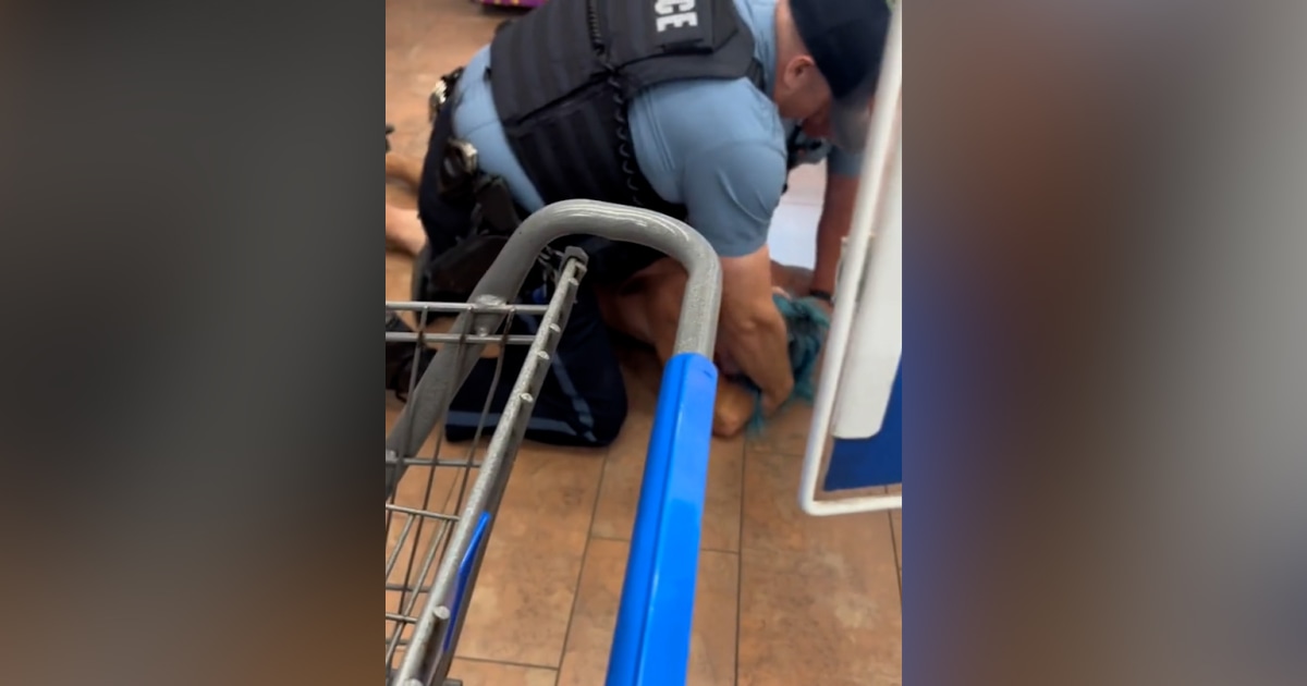 Police restrain man in Kansas City Walmart.