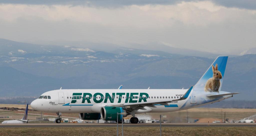 Frontier Airlines passenger arrested for hitting flight attendant with intercom phone.