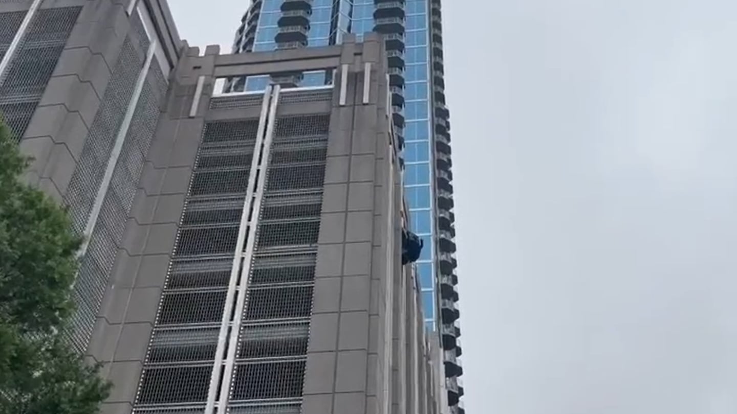 Featured image for Car Dangling from Uptown Parking Garage Shuts Down Roads