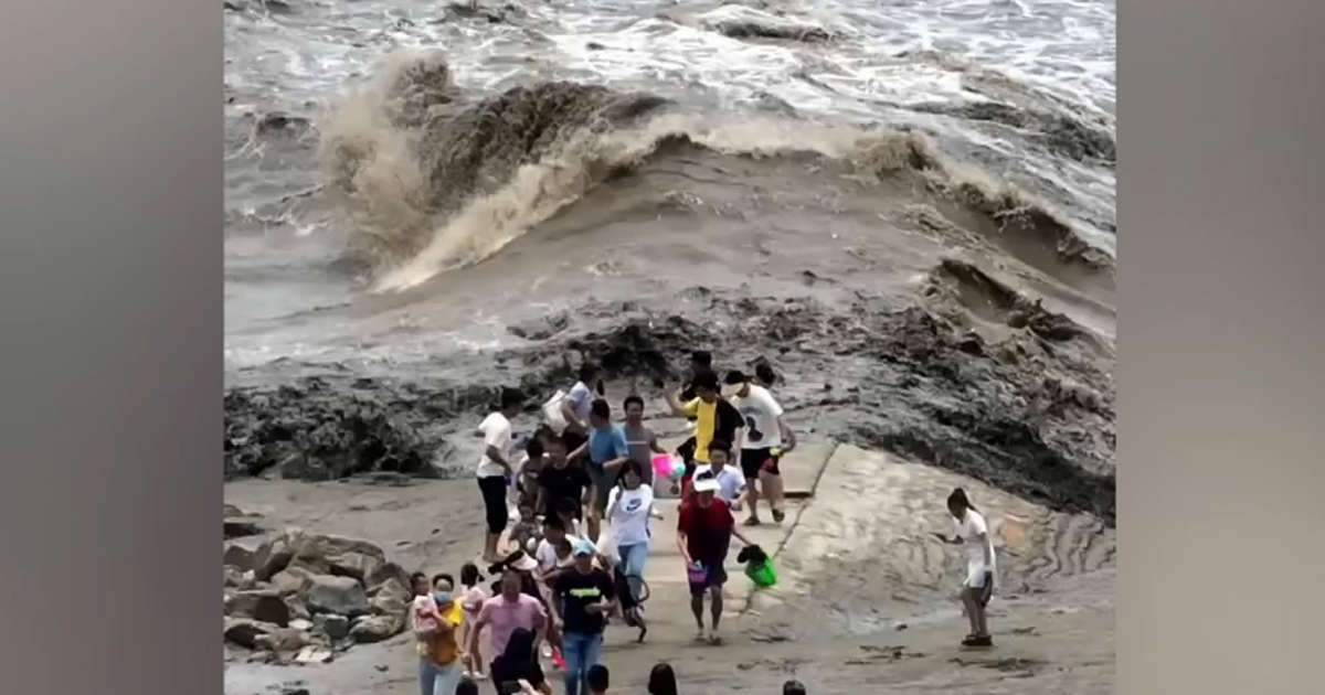 Onlookers narrowly escape powerful tidal bore.