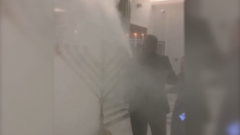 Far-right Polish lawmaker sparks controversy by extinguishing Hanukkah Menorah with fire extinguisher
