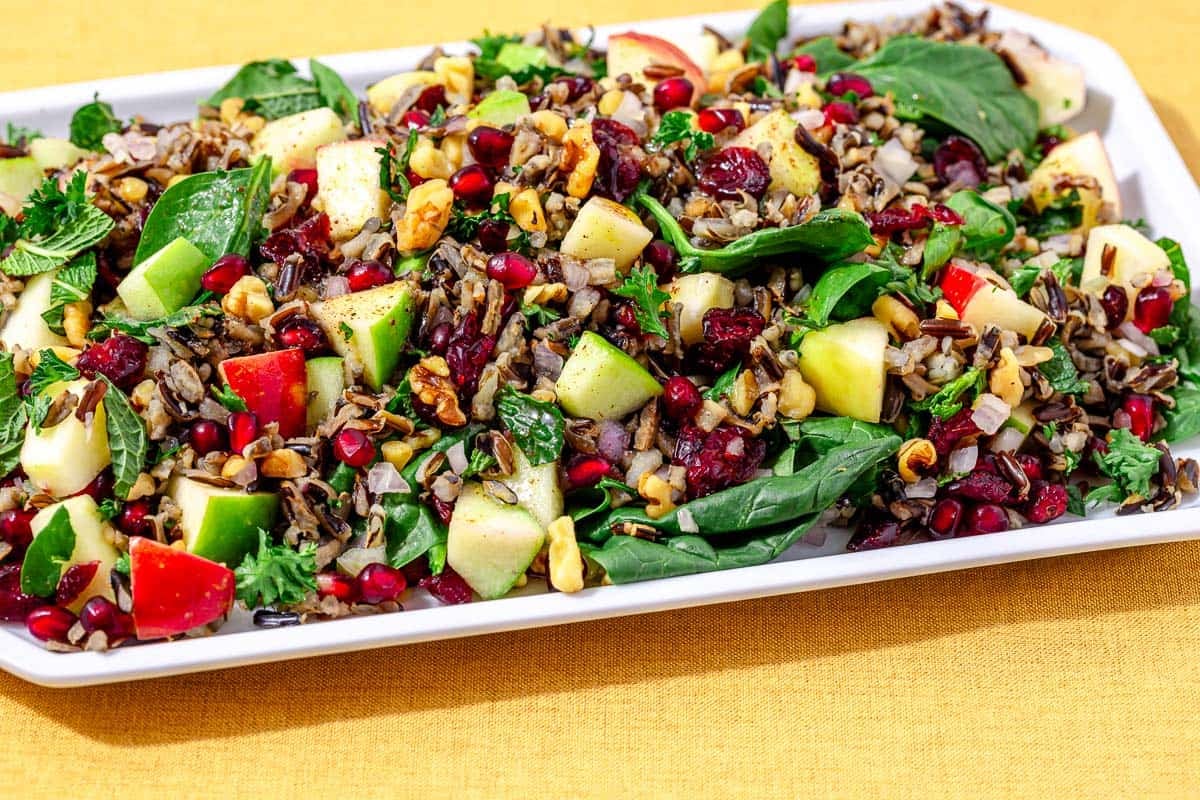 "Delicious Autumn Salad Bursting with Flavors: Wild Rice, Apples, Pomegranate, Cranberries, and Walnuts"